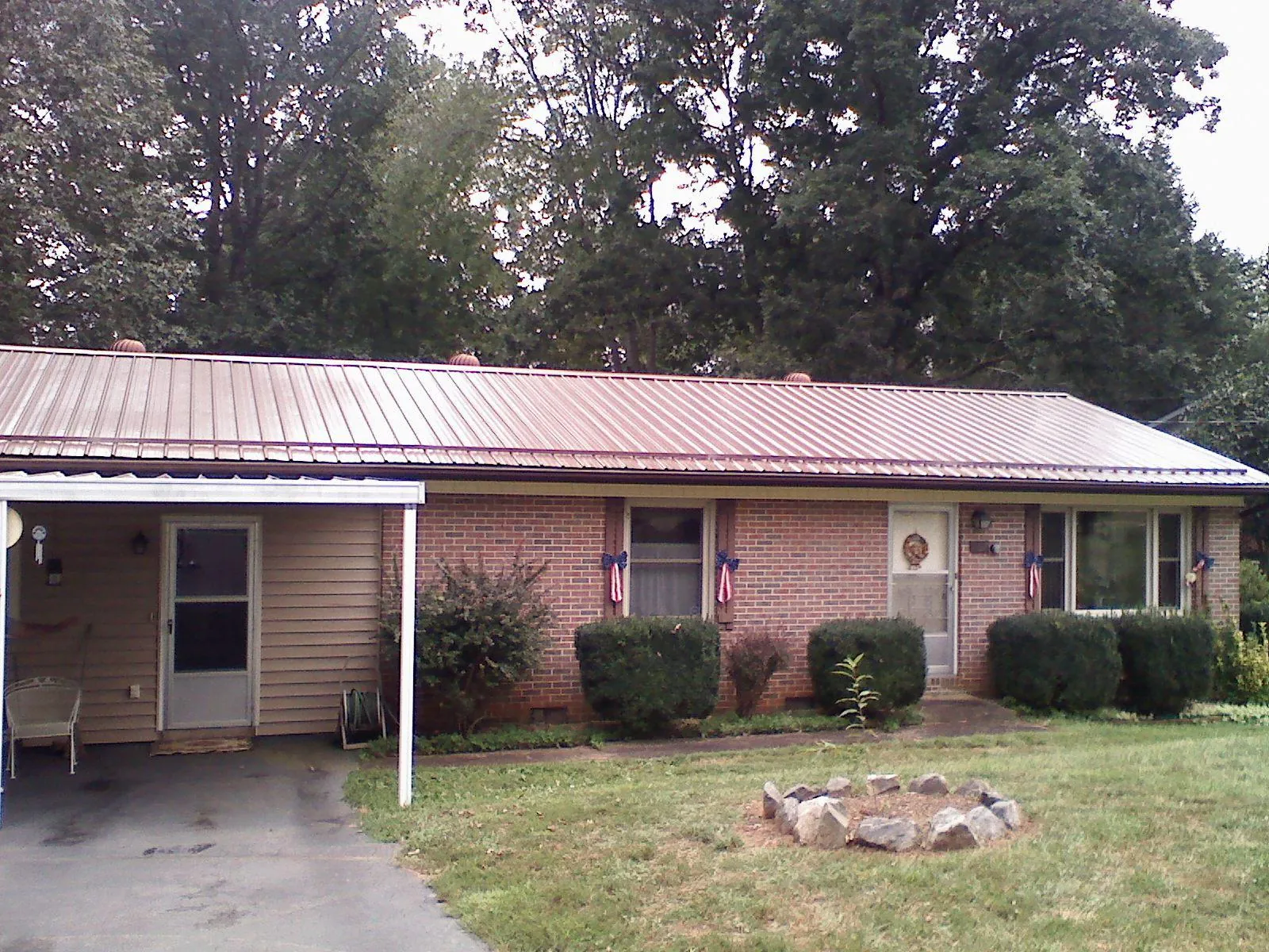 Bronze metal roof and carport on a brick ranch home — Roof Repair work by our crew in Ramona